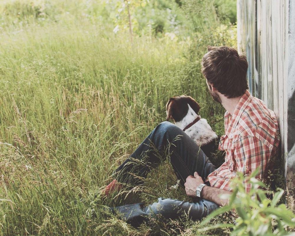 Homeowner relaxing at home with a pet, representing Khueman Insurance home coverage